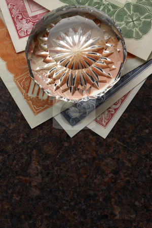 To use this stock image in your creative project, please select the size you need over to the right and click the "Add to Cart" button.
Your downloaded image will come with the Cutcaster watermark removed so don’t worry about the watermark you see on this page. Stock certificate still life stock photo, Stock certificates and faceted crystal paperweight shot on granite surface by James Barber
