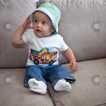 To use this stock image in your creative project, please select the size you need over to the right and click the "Add to Cart" button.
Your downloaded image will come with the Cutcaster watermark removed so don’t worry about the watermark you see on this page. Baby girl on the sofa stock photo, Little caucasian baby girl sitting on a sofa. by Mariusz Jurgielewicz