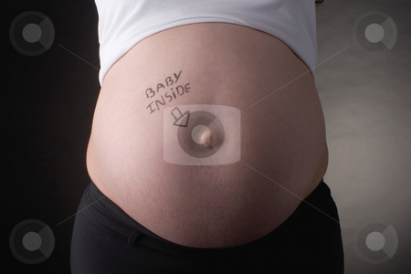 To use this stock image in your creative project, please select the size you need over to the right and click the "Add to Cart" button.
Your downloaded image will come with the Cutcaster watermark removed so don’t worry about the watermark you see on this page. Baby inside belly stock photo, Seven month pregnant belly with baby inside writting by Yann Poirier
