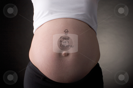 To use this stock image in your creative project, please select the size you need over to the right and click the "Add to Cart" button.
Your downloaded image will come with the Cutcaster watermark removed so don’t worry about the watermark you see on this page. Food goes in here belly stock photo, Seven month pregnant belly with arrow pointing up and food goes in here written on the stomach by Yann Poirier