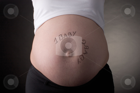 To use this stock image in your creative project, please select the size you need over to the right and click the "Add to Cart" button.
Your downloaded image will come with the Cutcaster watermark removed so don’t worry about the watermark you see on this page. One baby, two baby belly stock photo, Seven month pregnant belly with one baby, two baby written on the stomach by Yann Poirier