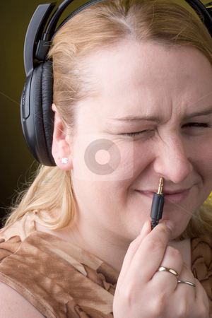To use this stock image in your creative project, please select the size you need over to the right and click the "Add to Cart" button.
Your downloaded image will come with the Cutcaster watermark removed so don’t worry about the watermark you see on this page. Women wrong plugin stock photo, Women trying to plugin headset in her nose with any success by Yann Poirier