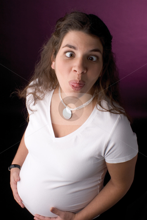 To use this stock image in your creative project, please select the size you need over to the right and click the "Add to Cart" button.
Your downloaded image will come with the Cutcaster watermark removed so don’t worry about the watermark you see on this page. Pregnant women making a facing stock photo, Seven month pregnant women making a funny face by Yann Poirier