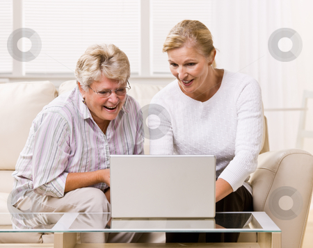 To use this stock image in your creative project, please select the size you need over to the right and click the "Add to Cart" button.
Your downloaded image will come with the Cutcaster watermark removed so don’t worry about the watermark you see on this page. Senior woman and daughter using laptop stock photo, Senior woman and daughter using laptop by Jonathan Ross