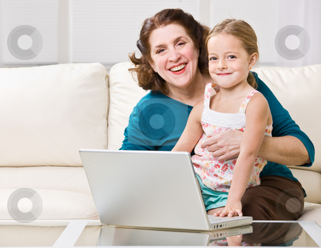 To use this stock image in your creative project, please select the size you need over to the right and click the "Add to Cart" button.
Your downloaded image will come with the Cutcaster watermark removed so don’t worry about the watermark you see on this page. Grandmother and granddaughter using laptop stock photo, Grandmother and granddaughter using laptop by Jonathan Ross