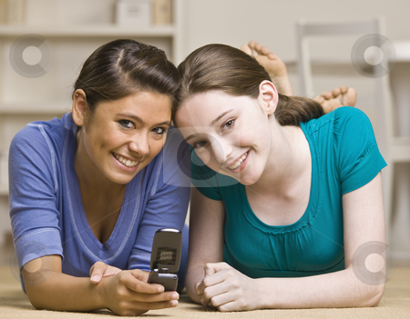 To use this stock image in your creative project, please select the size you need over to the right and click the "Add to Cart" button.
Your downloaded image will come with the Cutcaster watermark removed so don’t worry about the watermark you see on this page. Teenage girls text messaging on cell phone stock photo, Teenage girls text messaging on cell phone by Jonathan Ross