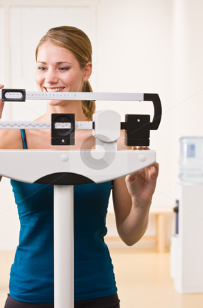 To use this stock image in your creative project, please select the size you need over to the right and click the "Add to Cart" button.
Your downloaded image will come with the Cutcaster watermark removed so don’t worry about the watermark you see on this page. Woman weighing herself on scales in health club stock photo, Woman weighing herself on scales in health club by Jonathan Ross