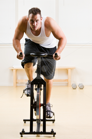 To use this stock image in your creative project, please select the size you need over to the right and click the "Add to Cart" button.
Your downloaded image will come with the Cutcaster watermark removed so don’t worry about the watermark you see on this page. Man riding stationary bicycle in health club stock photo, Man riding stationary bicycle in health club by Jonathan Ross