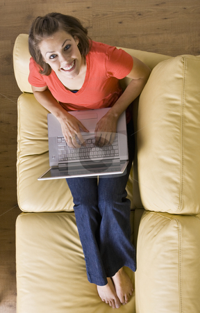 To use this stock image in your creative project, please select the size you need over to the right and click the "Add to Cart" button.
Your downloaded image will come with the Cutcaster watermark removed so don’t worry about the watermark you see on this page. Woman sitting on sofa using laptop stock photo, Woman sitting on sofa using laptop by Jonathan Ross