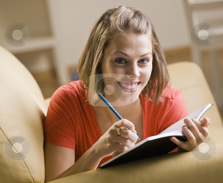 To use this stock image in your creative project, please select the size you need over to the right and click the "Add to Cart" button.
Your downloaded image will come with the Cutcaster watermark removed so don’t worry about the watermark you see on this page. Teenage girl writing in book stock photo, Teenage girl writing in book by Jonathan Ross