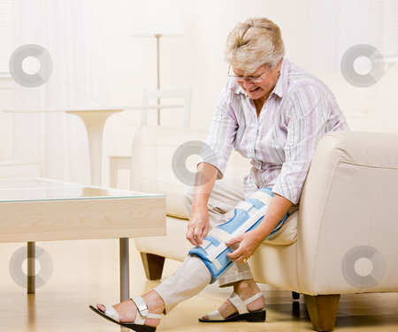 To use this stock image in your creative project, please select the size you need over to the right and click the "Add to Cart" button.
Your downloaded image will come with the Cutcaster watermark removed so don’t worry about the watermark you see on this page. Senior woman adjusting knee brace stock photo, Senior woman adjusting knee brace by Jonathan Ross