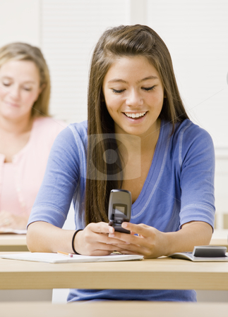 To use this stock image in your creative project, please select the size you need over to the right and click the "Add to Cart" button.
Your downloaded image will come with the Cutcaster watermark removed so don’t worry about the watermark you see on this page. Student text messaging on cell phone in classroom stock photo, Student text messaging on cell phone in classroom by Jonathan Ross