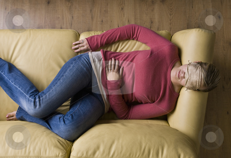 To use this stock image in your creative project, please select the size you need over to the right and click the "Add to Cart" button.
Your downloaded image will come with the Cutcaster watermark removed so don’t worry about the watermark you see on this page. Woman laying on sofa wearing sleep mask stock photo, Woman laying on sofa wearing sleep mask by Jonathan Ross