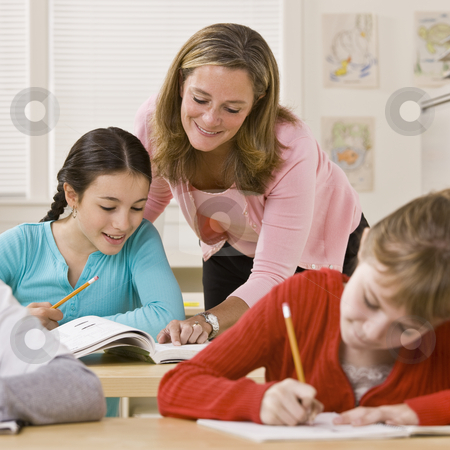 To use this stock image in your creative project, please select the size you need over to the right and click the "Add to Cart" button.
Your downloaded image will come with the Cutcaster watermark removed so don’t worry about the watermark you see on this page. Teacher helping student in classroom stock photo, Teacher helping student in classroom by Jonathan Ross
