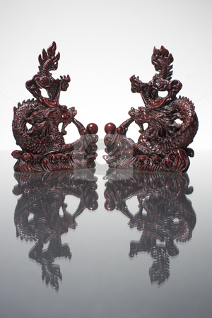 To use this stock image in your creative project, please select the size you need over to the right and click the "Add to Cart" button.
Your downloaded image will come with the Cutcaster watermark removed so don’t worry about the watermark you see on this page. 4 way dragon mirror stock photo, Two dragon statue reflecting on a grey surface by Yann Poirier