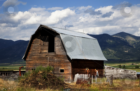 To use this stock image in your creative project, please select the size you need over to the right and click the "Add to Cart" button.
Your downloaded image will come with the Cutcaster watermark removed so don’t worry about the watermark you see on this page. Americana stock photo, Old Barn in the mountains with blue shy and clouds by Mark Smith