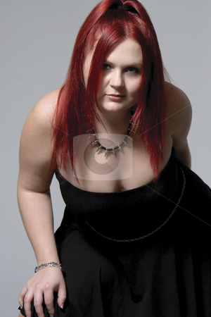 To use this stock image in your creative project, please select the size you need over to the right and click the "Add to Cart" button.
Your downloaded image will come with the Cutcaster watermark removed so don’t worry about the watermark you see on this page. Goth rock red hair chick stock photo, Red hair female model in suggestive position and goth look by Yann Poirier