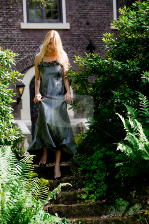 To use this stock image in your creative project, please select the size you need over to the right and click the "Add to Cart" button.
Your downloaded image will come with the Cutcaster watermark removed so don’t worry about the watermark you see on this page. Blond beauty in a castle garden dressed for gala stock photo, Beautifull blond in gala dress walking walking down some stairs in a castle garden by Frenk and Danielle Kaufmann