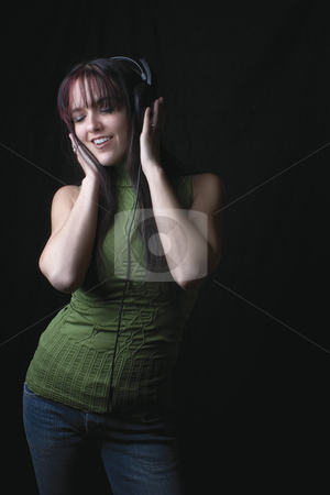 To use this stock image in your creative project, please select the size you need over to the right and click the "Add to Cart" button.
Your downloaded image will come with the Cutcaster watermark removed so don’t worry about the watermark you see on this page. Fashion model - music and dancing stock photo, Twenty something fashion model listening to music and dancing by Yann Poirier