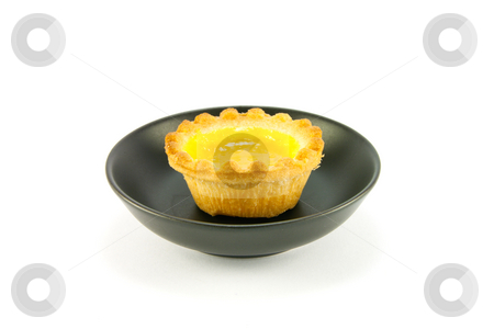 To use this stock image in your creative project, please select the size you need over to the right and click the "Add to Cart" button.
Your downloaded image will come with the Cutcaster watermark removed so don’t worry about the watermark you see on this page. Lemon Jam Tart stock photo, Single small yellow lemon jam tart in a small black dish with a white background by Keith Wilson