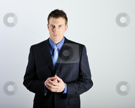To use this stock image in your creative project, please select the size you need over to the right and click the "Add to Cart" button.
Your downloaded image will come with the Cutcaster watermark removed so don’t worry about the watermark you see on this page. Man Wearing Business Suit stock photo, A young man is wearing a suit and a blue tie. He is looking at the camera. Square framed shot. by Zee Images