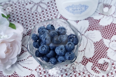 To use this stock image in your creative project, please select the size you need over to the right and click the "Add to Cart" button.
Your downloaded image will come with the Cutcaster watermark removed so don’t worry about the watermark you see on this page. Blueberries stock photo, Bowl of blueberries with roses in the background and space for copy by Shirley Mathews
