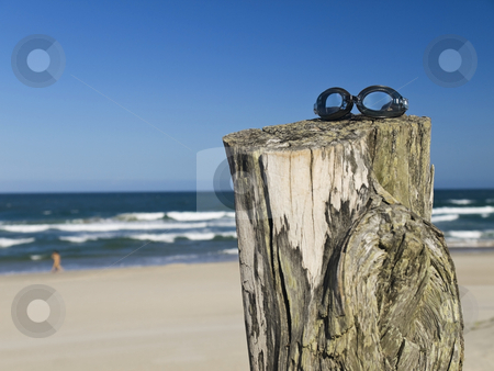 To use this stock image in your creative project, please select the size you need over to the right and click the "Add to Cart" button.
Your downloaded image will come with the Cutcaster watermark removed so don’t worry about the watermark you see on this page. Goggles stock photo, A pair of goggles sitting over a log in the beach. by Ignacio Gonzalez Prado
