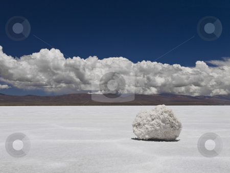 To use this stock image in your creative project, please select the size you need over to the right and click the "Add to Cart" button.
Your downloaded image will come with the Cutcaster watermark removed so don’t worry about the watermark you see on this page. With a pinch of salt stock photo, A salt rock sitting on huge a salt field. Mountains on the background. by Ignacio Gonzalez Prado