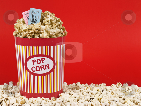 To use this stock image in your creative project, please select the size you need over to the right and click the "Add to Cart" button.
Your downloaded image will come with the Cutcaster watermark removed so don’t worry about the watermark you see on this page. Sweet movie stock photo, A popcorn bucket over a red background. Movie stubs sitting over the popcorn. by Ignacio Gonzalez Prado