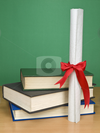 To use this stock image in your creative project, please select the size you need over to the right and click the "Add to Cart" button.
Your downloaded image will come with the Cutcaster watermark removed so don’t worry about the watermark you see on this page. Graduation day stock photo, A pile of books and a diploma. Blank chalkboard on the background. by Ignacio Gonzalez Prado