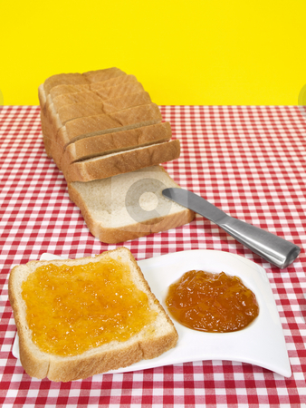 To use this stock image in your creative project, please select the size you need over to the right and click the "Add to Cart" button.
Your downloaded image will come with the Cutcaster watermark removed so don’t worry about the watermark you see on this page. Bread and jam stock photo, A slice of bread spread with jam beside a loaf of sliced bread. by Ignacio Gonzalez Prado