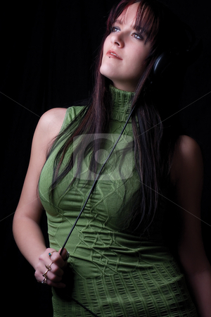 To use this stock image in your creative project, please select the size you need over to the right and click the "Add to Cart" button.
Your downloaded image will come with the Cutcaster watermark removed so don’t worry about the watermark you see on this page. Fashion model - listening to music stock photo, Twenty something fashion model listening to music with big headphone by Yann Poirier