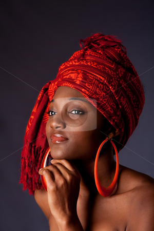 To use this stock image in your creative project, please select the size you need over to the right and click the "Add to Cart" button.
Your downloaded image will come with the Cutcaster watermark removed so don’t worry about the watermark you see on this page. African woman with headwrap stock photo, Beautiful African-American woman wearing a traditional tribal red orange head scarf and big orange hoop earrings, supporting her chin with hand, isolated. by Paul Hakimata
