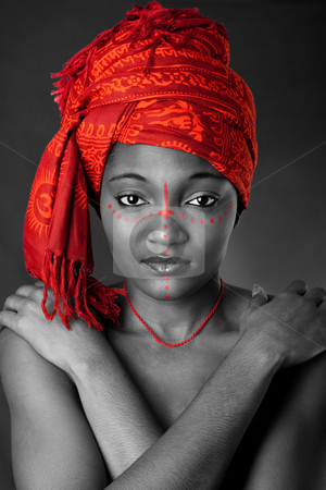 To use this stock image in your creative project, please select the size you need over to the right and click the "Add to Cart" button.
Your downloaded image will come with the Cutcaster watermark removed so don’t worry about the watermark you see on this page. Tribal African woman with headwrap stock photo, Beautiful traditional African-American woman wearing a authentic tribal red orange head scarf and red dotted makeup, heaving arms crossed on chest, isolated. by Paul Hakimata
