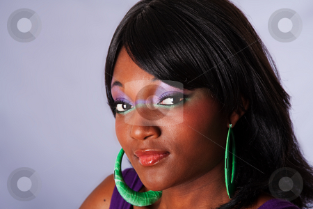 To use this stock image in your creative project, please select the size you need over to the right and click the "Add to Cart" button.
Your downloaded image will come with the Cutcaster watermark removed so don’t worry about the watermark you see on this page. Beautiful face of African woman stock photo, Face portrait of a young beautiful African-American woman with purple-green makeup with long straight black hair, isolated by Paul Hakimata