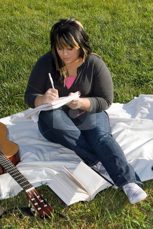 To use this stock image in your creative project, please select the size you need over to the right and click the "Add to Cart" button.
Your downloaded image will come with the Cutcaster watermark removed so don’t worry about the watermark you see on this page. Musician Writing a Song stock photo, A young musician writing in her notebook while sitting in the grass on a nice day. by Todd Arena
