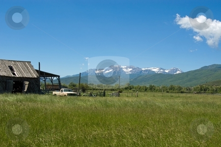 To use this stock image in your creative project, please select the size you need over to the right and click the "Add to Cart" button.
Your downloaded image will come with the Cutcaster watermark removed so don’t worry about the watermark you see on this page. Mountain Valley stock photo, Ramshackle barns and an old truck at a farm in a mountain valley. by Andrew Orlemann
