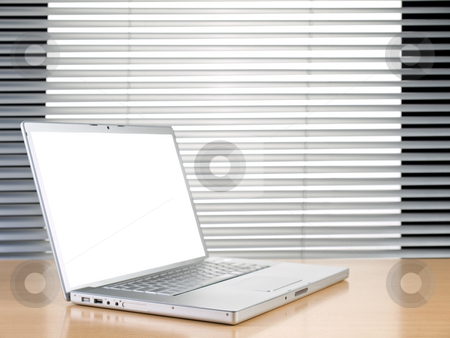 To use this stock image in your creative project, please select the size you need over to the right and click the "Add to Cart" button.
Your downloaded image will come with the Cutcaster watermark removed so don’t worry about the watermark you see on this page. Laptop and blinds stock photo, A laptop on a table at a modern office. by Ignacio Gonzalez Prado