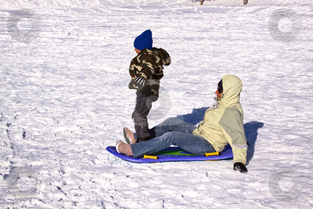To use this stock image in your creative project, please select the size you need over to the right and click the "Add to Cart" button.
Your downloaded image will come with the Cutcaster watermark removed so don’t worry about the watermark you see on this page. Mother and Son Sledding down the Hill stock photo, Mother and Son Sledding down the Hill while the Boy Trying to Stand Up by Mehmet Dilsiz