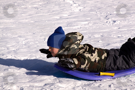 To use this stock image in your creative project, please select the size you need over to the right and click the "Add to Cart" button.
Your downloaded image will come with the Cutcaster watermark removed so don’t worry about the watermark you see on this page. Little Boy Sledding down the Hill stock photo, Little Boy Sledding down the Hill - Winter Scenes by Mehmet Dilsiz