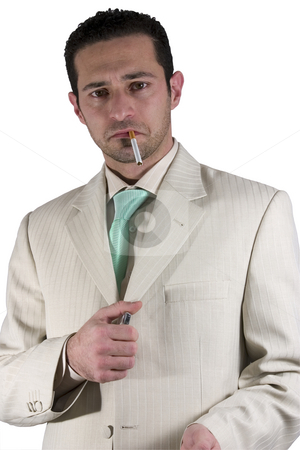 To use this stock image in your creative project, please select the size you need over to the right and click the "Add to Cart" button.
Your downloaded image will come with the Cutcaster watermark removed so don’t worry about the watermark you see on this page. Businessman lighting up a cigarette stock photo, Isolated Businessman lighting up a cigarette by Mehmet Dilsiz