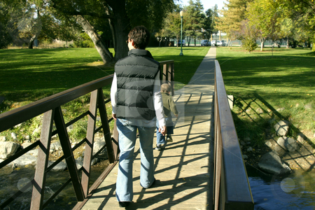 To use this stock image in your creative project, please select the size you need over to the right and click the "Add to Cart" button.
Your downloaded image will come with the Cutcaster watermark removed so don’t worry about the watermark you see on this page. Mother and Son walking on the Park Bridge stock photo, Mother and Son walking on the Bridge in a Park by Mehmet Dilsiz