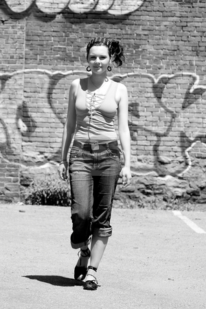 To use this stock image in your creative project, please select the size you need over to the right and click the "Add to Cart" button.
Your downloaded image will come with the Cutcaster watermark removed so don’t worry about the watermark you see on this page. Urban girl stock photo, Twenty something urban fashion walking in front of a graffitti wall at high noon by Yann Poirier