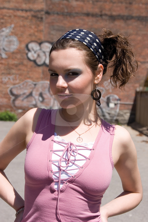 To use this stock image in your creative project, please select the size you need over to the right and click the "Add to Cart" button.
Your downloaded image will come with the Cutcaster watermark removed so don’t worry about the watermark you see on this page. Urban girl stock photo, Twenty something urban fashion in front of a graffitti wall at high noon by Yann Poirier