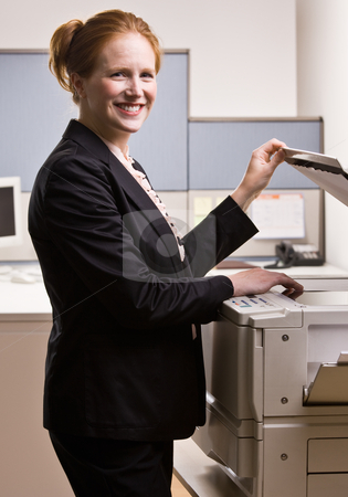 To use this stock image in your creative project, please select the size you need over to the right and click the "Add to Cart" button.
Your downloaded image will come with the Cutcaster watermark removed so don’t worry about the watermark you see on this page. Businesswoman copying papers in office stock photo, Businesswoman copying papers in office by Jonathan Ross