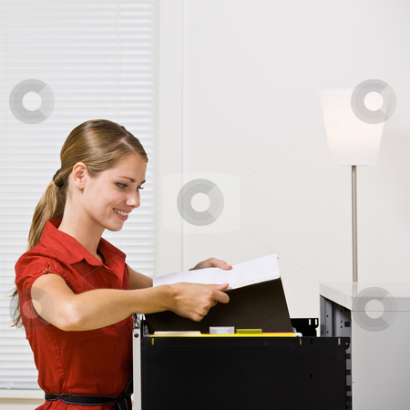 To use this stock image in your creative project, please select the size you need over to the right and click the "Add to Cart" button.
Your downloaded image will come with the Cutcaster watermark removed so don’t worry about the watermark you see on this page. Businesswoman putting file in file cabinet stock photo, Businesswoman putting file in file cabinet by Jonathan Ross