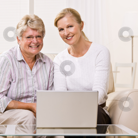To use this stock image in your creative project, please select the size you need over to the right and click the "Add to Cart" button.
Your downloaded image will come with the Cutcaster watermark removed so don’t worry about the watermark you see on this page. Senior woman and daughter using laptop stock photo, Senior woman and daughter using laptop by Jonathan Ross