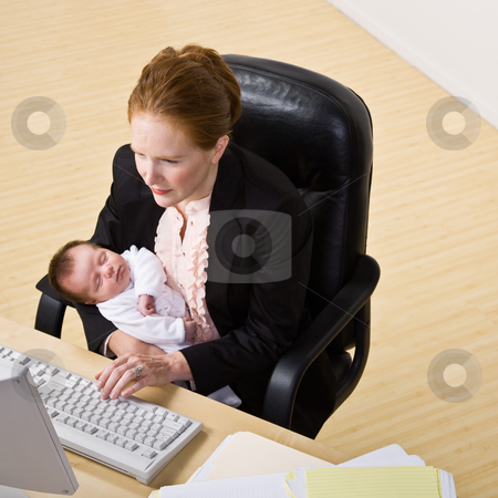 To use this stock image in your creative project, please select the size you need over to the right and click the "Add to Cart" button.
Your downloaded image will come with the Cutcaster watermark removed so don’t worry about the watermark you see on this page. Businesswoman holding baby at desk stock photo, Businesswoman holding baby at desk by Jonathan Ross