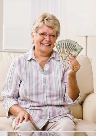 To use this stock image in your creative project, please select the size you need over to the right and click the "Add to Cart" button.
Your downloaded image will come with the Cutcaster watermark removed so don’t worry about the watermark you see on this page. Senior woman holding cash stock photo, Senior woman holding cash by Jonathan Ross