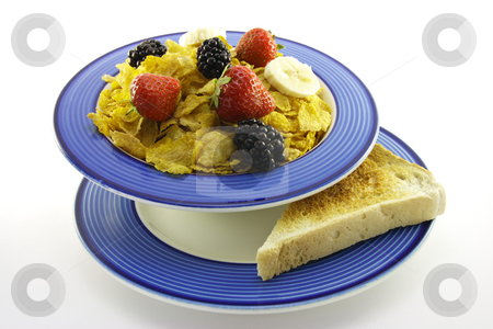 To use this stock image in your creative project, please select the size you need over to the right and click the "Add to Cart" button.
Your downloaded image will come with the Cutcaster watermark removed so don’t worry about the watermark you see on this page. Cornflakes and Fruit with Toast stock photo, Cornflakes with strawberries, blackberries and banana in a round blue bowl with a slice of toast on a plate with a white background by Keith Wilson